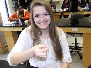 HOLLY LONG proudly displays a strand of her DNA. 