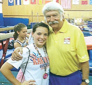 Kay Bush poses for a photo with noted Romanian gymnastics coach Bela Karolyi.|Submitted