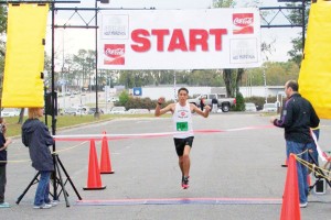 Nineteen-year-old Stanley Linton, of Crawfordville, Fla., crosses the finish line with the first overall time of 1 hour, 17 minutes, 27 seconds, in the second annual Bainbridge Half Marathon on Saturday.