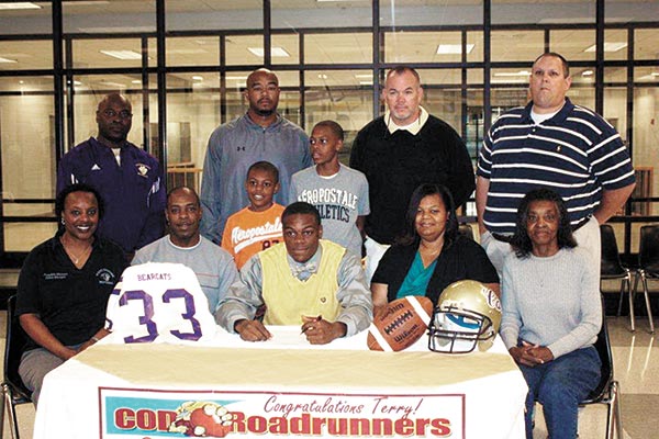 Bainbridge High School senior football player Terry Lewis signed a football scholarship with College of the Desert, in Palm Desert, Calif., recently at the BHS gym. Shown at the signing are: front row, left to right, Lewis’s aunt Frankie Lewis Malone, his father Terry Lewis Sr., Lewis, his mother Cherryl Lewis and his grandmother Lucille Lewis; middle row, left to right, his brothers Caleb and Aaron Lewis; back row, left to right, BHS assistant football coaches Larry Cosby, Leonard Guyton, Tom Wheeler and Jodie Sprenkle.