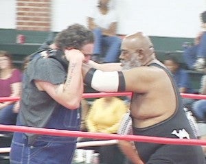 “The Black Assassin,” also known as Rev. Adren Bivins of Bainbridge, grapples with his opponent in a charity wrestling match earlier this month in Donalsonville.|Submitted
