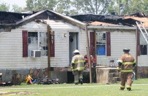 Firefighters enter the house at 184 Bradwell-Laster Road in Climax, after it was badly damaged in a fire late Thursday morning.|Justin Schuver