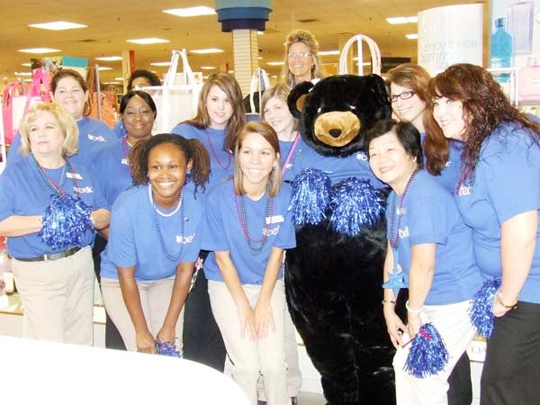 FUZZY VISITOR: Corporate mascot “Belkie Bear” joined local Belk associates for the fun Wednesday morning at the 125th birthday celebration.