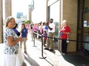 ANXIOUSLY WAITING: Customers wait in line to be the first 100 to enter the Belk store at 9 a.m. and receive gift cards.