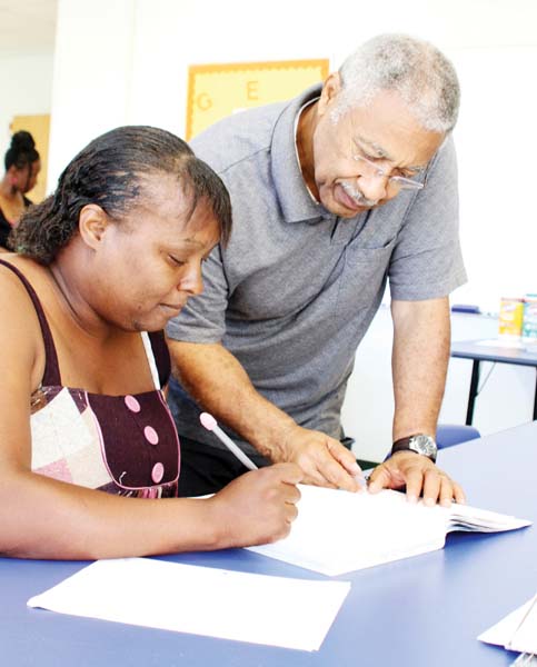 TICKET TO DREAMS: Getting some one-on-one attention is Fasiska Lyles of Blakely, who is taking classes for a GED at the Bainbridge State College’s Early County Center in Blakely. Assisting her is Sam Williams, instructor of Adult Education/GED at the Early County Center.