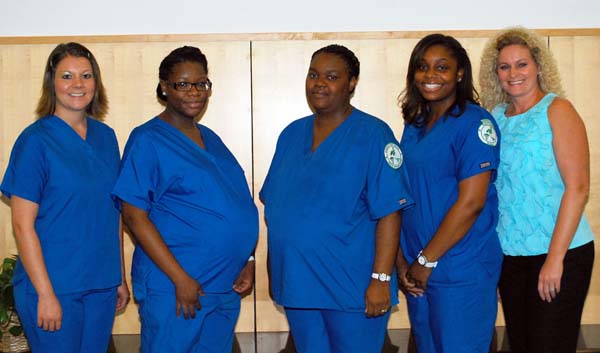 Graduates of the Bainbridge State College’s Medical Assisting program stand with their instructor, Sherry Harrison. From the left, are Amelia Jensen, LaShondra Harris, Ronnisha Bush and Monique Groomes, all from Bainbridge, and Harrison.