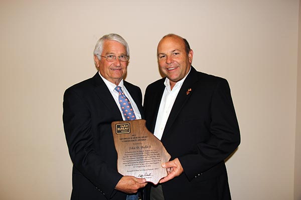 Georgia Farm Bureau President Zippy Duvall, right, presents the 2013 GFB Commodity Award to former Sen. John Bulloch.