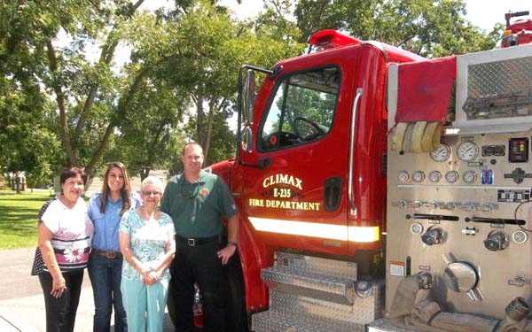Climax Golden Agers Mary Breen and Gwen Wingate look over the Climax VFD Fire Truck after a program on safety by the volunteers Malori Maxwell and Christopher Wynn.