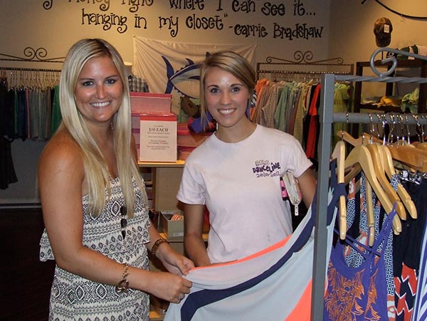 Bella’s Boutique associate Sydney Smith, assists BHS senior Caitie Gordon in the selection of a new dress.