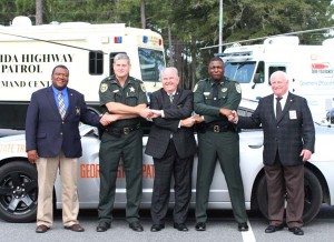 Sheriffs from Florida and Georgia link hands as a sign of support for the Hands Across the Border campaign was held at Bainbridge State College on Monday and Tuesday. From the left, are Early County, Ga., Sheriff William C. Price; Jackson County, Fla., Sheriff Lou Roberts; Decatur County, Ga., Sheriff Wiley Griffin; Gadsden County, Fla., Sheriff Morris Young, and Grady County, Ga., Sheriff Harry Young.