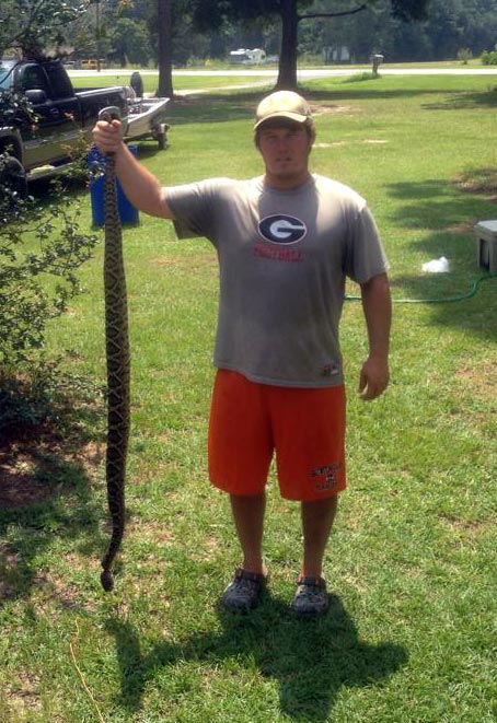 Woodie Warr caught this rattlesnake, which measured five feet, five inches, on family property near Brinson. The snake had 14 rattlers and one button.