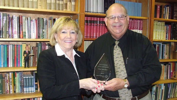 Pat Harrell and the Rev. Paul Medley display the plaque presented to Medley for being named the Special Olympics Coordinator of the Year for the State of Georgia.