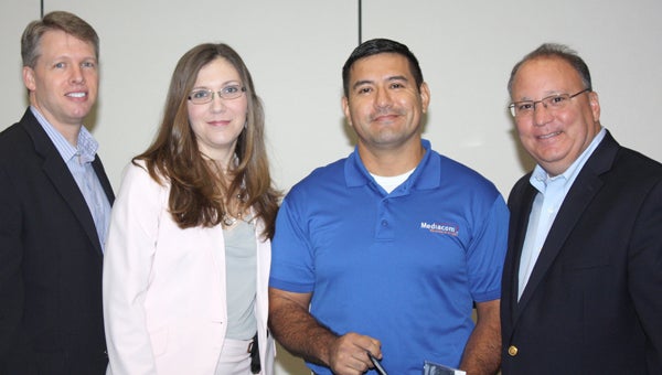  Jose Guerrero of Bainbridge, second from right, is recognized for outstanding customer service by his company’s top corporate leaders. Pictured from left are Dan Templin, senior vice president for business services; Melanie Hannasch, director; and John Pascarelli, executive vice president for operations.