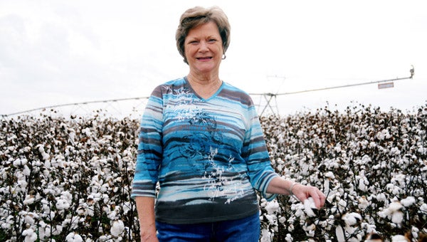 Kathy Hornsby stands in one of the many Rentz Family Farm cotton fields in Decatur County that is getting ready to be harvested.