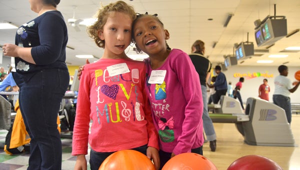 Friends Lindsey Hiers and LeBresha Wimberly enjoy a morning full of bowling Tuesday as the Special Olympians were invited to bowl at the Langston Gray Bowling Center. -- Ashley Johnson