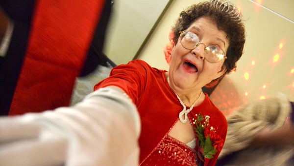 Special Olympians of Decatur County attended the annual Snowflake Ball Saturday night at the Kirbo Center. Above, Betty Meaders shows off her red velvet dress and new gloves on the dance floor.