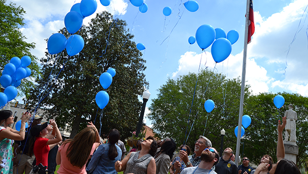 Community members and law enforcement officers gathered in Willis Park Wednesday to release 77 balloons representing the 77 children abused in Decatur, Mitchell, Grady, Calhoun and Baker counties in 2013.