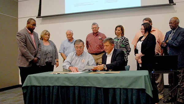 County Chairman Frank Loeffler and Bainbridge Mayor Edward Reynolds sign pledges of support for a newly formed government council that will bring the city and county together for formal, quarterly meetings in hopes of making the region stronger for residents and elected bodies and their communication.