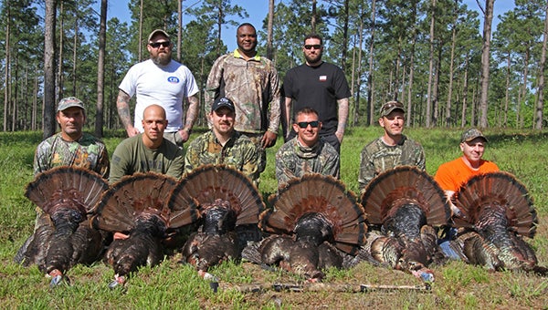 Wounded Warriors display the trophies they got at Saturday’s Wounded Warriors turkey hunt at Southland Plantation. In front, from left to right are Jason Bass, Marco Davis, Michael Johnson, George Faulk, Jason Hewitt, and Michael Bieble. In back are Jonathan Hitchcock, Kevin McCallister and Jake Lerner. Not pictured: Taras  Kryzaka.
