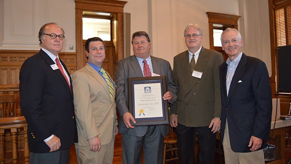 City Manager Chris Hobby, center, stands with officials from the Georgia Trust for Historic Preservation. The City of Bainbridge won two top state awards Friday for the City Hall project. 