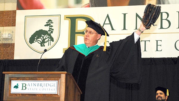 State Sen. Dean Burke stretches out as if catching a fly ball during his commencement address Saturday.