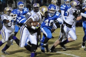 close game: Freshman running back Dameon Pierce charges around the outside during Friday’s game against West Laurens in Dexter. Pierce finished with 124 yards rushing on the night.