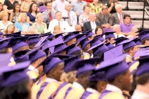 Senior BHS students donning purple caps and gowns eagerly await their diplomas