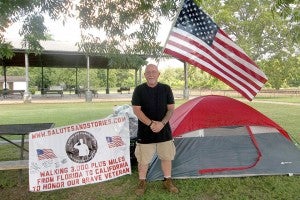 Mac McQuown, a U.S. Marine veteran, stands with his humble setup during his stay in Parker’s Park in Climax. McQuown’s plan is to walk across the country from Daytona Beach, Florida, to California.