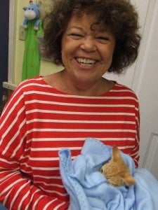 Dennie Nichols holds a tiny kitten that has been rescued and needs individual care. 