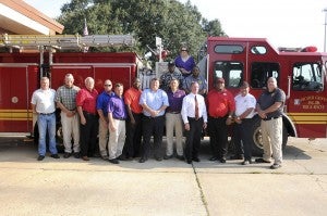 In front, from left: assistant city manager Roy Oliver, Decatur County commissioner Russell Smith, commissioner Pete Stephens, commissioner Rusty Davis, city councilman Don Whaley, commission chairman Dennis Brinson, Bainbridge city manager Chris Hobby, Mayor Edward Reynolds, Decatur County administrator Alan Thomas, commissioner George Anderson, Decatur County Fire and Rescue chief .Charlie McCann and BPS Fire Prevention Major Doyle Welch. In back: Councilman Luther Conyers, BPS Director Jerry Carter and city councilwoman Roslyn Palmer.