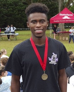 Poncherella Leonard smiles with his medal after setting the BHS 5K record in a time of 15:56.