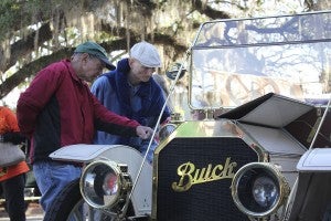 Visitors to the square check out what’s under the hood of a refurbished 1910 Buick Model 19 Touring. | Shelby Farmer, Post-Searchlight
