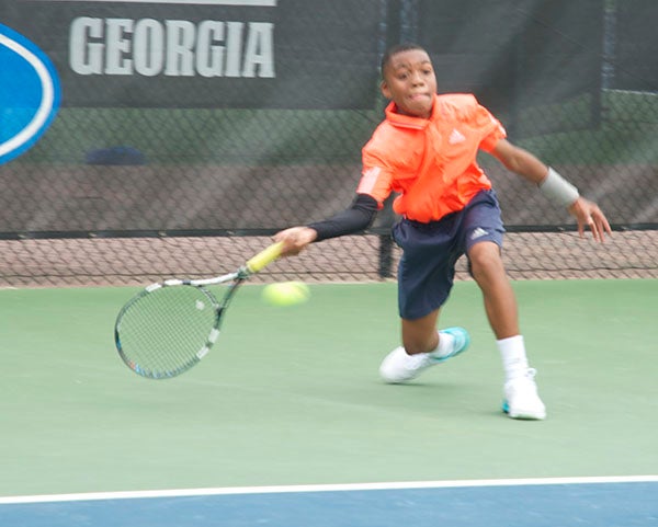 Brandon O’Connor — Post-Searchlight Winning shot: Edward Tymes, 13, returns a volley in the boys’ 14 singles championship match. He won the match 6-4, 6-2 over Gray Lewis to win the championship. 