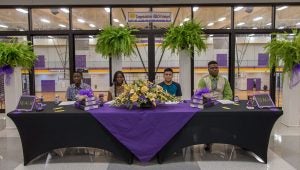 Jamil Tucker, Anala McIntyre, Eliel Lopez and Lawson Chandler sit together during their REACH scholarship signing event.